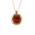 Rich rose gold garnet bubble pendant. A stunning deep red garnet gemstone, set into 9ct rose gold and suspended from an adjustable rose gold chain. 