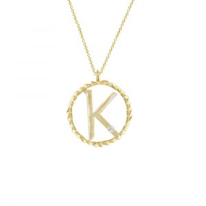 A single diamond set in a 9ct yellow gold initial K pendant. The letter K sits within a twisted gold circle and hangs from an adjustable yellow gold chain.